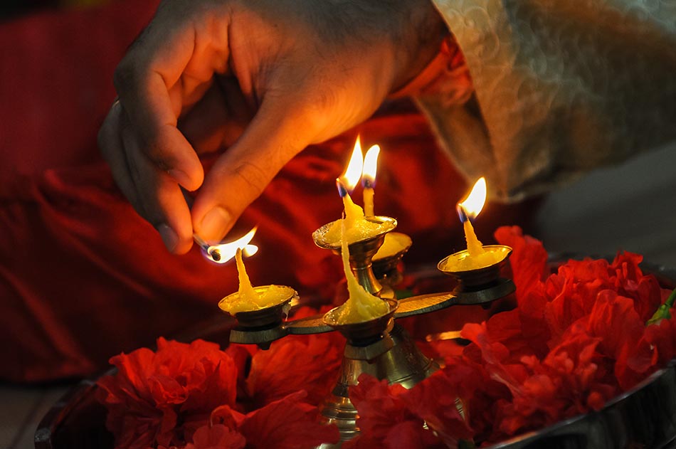 diwali festival of lights , hand lighting an indian oil lamp - Creative ...